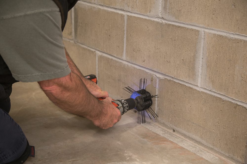 Remove any paint, dirt or residue from concrete basement floor